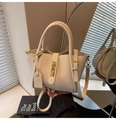 Detail of creamy white litchi grain leather texture and gold buckle on a stylish tote bag - Khaki