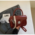 Minimalist deep red leather handbag with metallic twist lock and woven rope accessory - Wine Red with Pendant