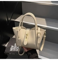Minimalist beige pebble leather crossbody handbag with round handles and gold twist lock - Off White