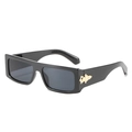 Flat lay of retro square sunglasses with thick black frames and gold metal accents - Black Frame / Black Lens