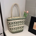 Green and cream woven straw tote bag with slim handles and a minimalist summer design - Green