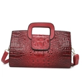 Minimalist burgundy tote bag with crocodile texture and metal hardware on white background - Burgundy
