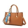 Brown lychee leather handbag with printed silk scarf and adjustable strap on white background - Tan