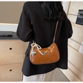 Brown faux leather crescent bag with metallic bow and pearl pendant details - Brown