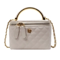 Elegant cream quilted bucket bag with gold arc handle and floral hardware detail - White