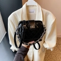 Glossy black quilted handbag with silver chain strap and square turn-lock closure - Black