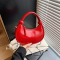 Chic red crescent handbag with glossy synthetic leather and a silver chain strap - Red