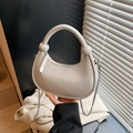 Chic beige half-moon handbag with twisted top handle and elegant silver chain strap - Gray
