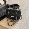 Glossy black quilted crossbody bag with silver chain strap and metal turn-lock - Black