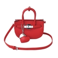 Red pebbled leather mini handbag with silver twist lock and heart charm on white background - Red
