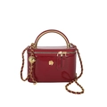 Burgundy patent leather handbag with gold floral buckle and chain strap on white background - Red