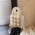 Mini cream pearl beaded handbag with woven top handle and long crossbody strap - White