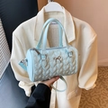 Light blue heart-quilted cylinder shoulder bag with gold bow detail and twin handles - Blue