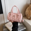 Pink heart quilted boston bag with top handles and adjustable strap in hand - Pink
