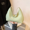 Glossy light green patent leather hobo bag with sleek minimalist shoulder strap design - Green