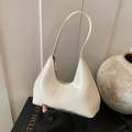 Chic cream white hobo bag in glossy patent leather finish with minimalist curved design - White
