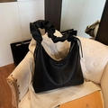 Minimalist black pebbled leather tote bag featuring ruched handle and drawstring details - Black