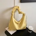 Bright yellow pebbled leather shoulder bag with stylish scrunchie handle for women - Yellow