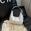 Minimalist white patent leather crescent bag with mirror finish on premium packaging - White