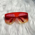 Chic oversized square sunglasses with red-yellow gradient frames on white plush background - Red and Yellow Frame