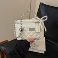 White quilted shoulder bag with silver hardware, pearl bow charm, and chain strap - Pearl Bow Charm / Off White