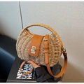 Détail d'un sac à main en paille tressée avec poignée en cuir marron et fermoir en métal - Khaki