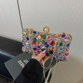 Luxury clutch bag featuring multi-color rhinestones and a large pearl clasp closure - Colorful
