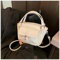 White lychee pattern leather handbag with crossbody strap and front pocket buckle detail - White