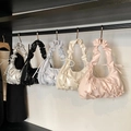 Pleated bow shoulder bags in five colors hanging on a display rack for spring 2025 fashion - Blue