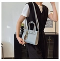 Detail of light blue lychee pattern leather bag with silver buckle and decorative silk scarf - Blue Gray