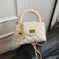 Elegant white quilted crossbody bag with golden twist lock and top handle for women - White