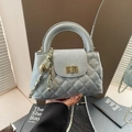 Quilted light blue leather handbag with gold chain strap and elegant turn-lock closure - Blue