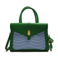 Green and purple wavy patchwork handbag with gold clasp and dual handles on white background - Green