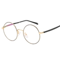 Monture de lunettes ronde rétro en métal doré vue sous un angle latéral de 45 degrés - Standard or et noir