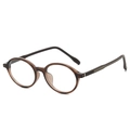 Occhiali rotondi vintage in marrone traslucido con eleganti accenti metallici sulle aste - Montatura Tè Scuro Lenti Bianche