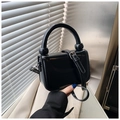 Minimalist black glossy crossbody bag with cylindrical handle and sphere detail - Black