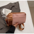 Pink minimalist crossbody bag with wide strap shown in a stylish lifestyle setting - Pink