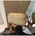 Detail of off-white canvas crossbody bag with brown zippers and wide nylon strap - Khaki
