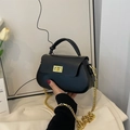 Chic black mini crossbody bag with gold chain strap and elegant knotted handle design - Black