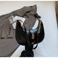 Detail of black PU leather half-moon bag with bold silver chain and metallic buckle - Black