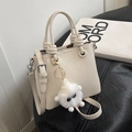 Elegante borsa beige in pelle con manico annodato e ciondolo mostro di peluche - Con Ciondolo Mostro di Peluche / Bianco Sporco
