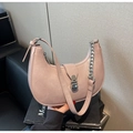 Detail shot of pink half-moon shoulder bag showing textured leather and silver chain - Pink