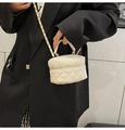 Detail of white quilted leather mini vanity bag with gold chain strap on black blazer - Off White