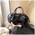Glossy black leather crossbody bag featuring silver metallic details and knotted handles - Black