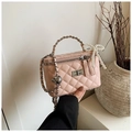 Pink quilted vanity box bag with chain handle and pearl bow detail in a minimalist setting - Pink With Pendant