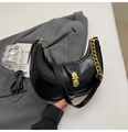 Detail of black crescent hobo bag with gold metal buckle and chunky chain strap - Black