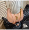 Detailed shot of pink crescent underarm bag featuring gold chain and smooth leather - Pink