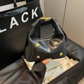 Black crescent hobo bag in glossy patent leather with gold animal charm accents - No Pendant / Black