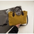 Minimalist bright yellow lychee leather handbag with dark brown contrast strap and handles - Yellow