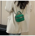 Mini green quilted crossbody bag with gold chain strap worn over a beige blazer - Dark Green